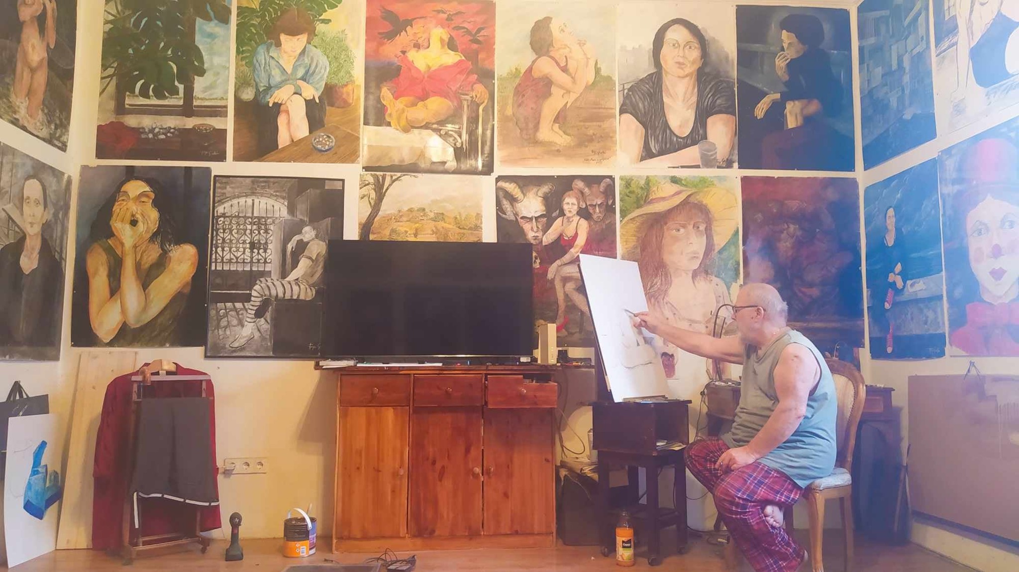 Artist surrounded by paintings